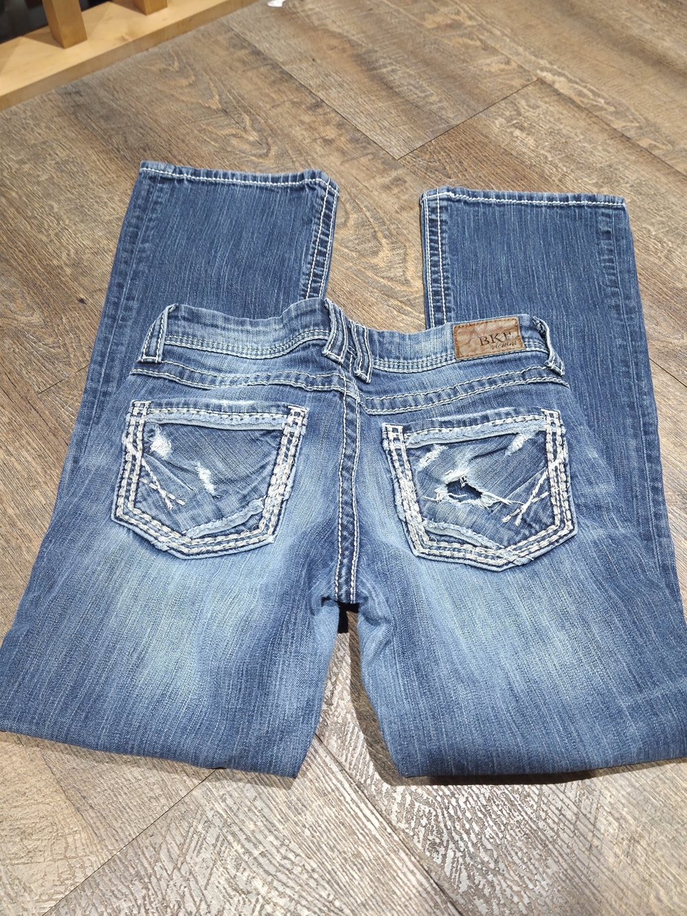 BKE Women's Boot Cut Jeans in Faded Blue with Distressed Back Pockets